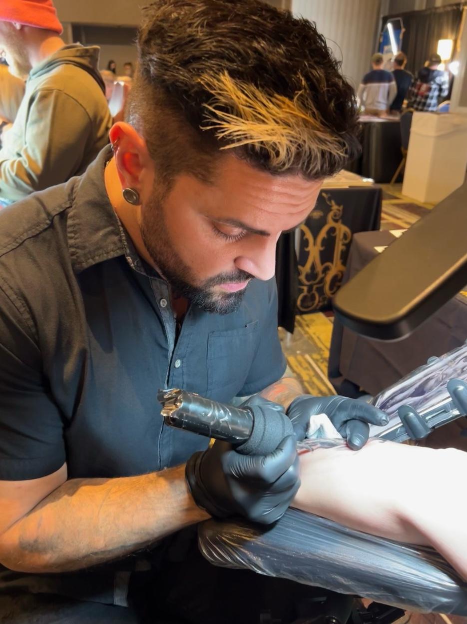 Jesse Vickers tattoo artist at convention — realism tattoo Michigan